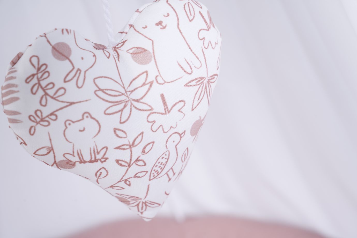 Heart-shaped pillow with brown animal and plant outlines on white fabric, Stubenwagen accessory. - Mionido - Stubenwagen Maxi (natur)